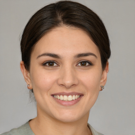 Joyful white young-adult female with medium  brown hair and brown eyes