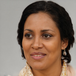 Joyful black adult female with medium  brown hair and brown eyes