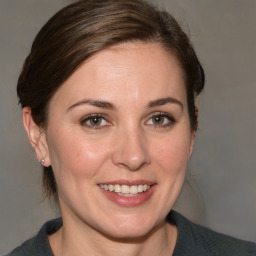 Joyful white adult female with medium  brown hair and brown eyes