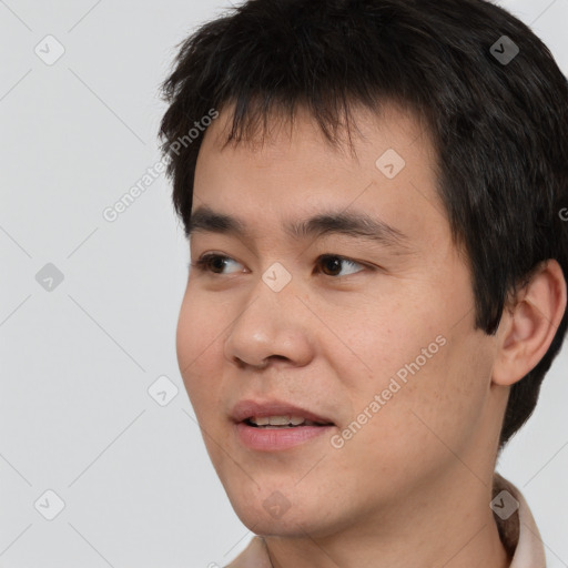 Joyful asian young-adult male with short  black hair and brown eyes