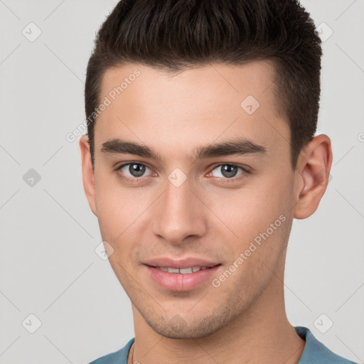 Joyful white young-adult male with short  brown hair and brown eyes