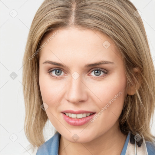 Joyful white young-adult female with long  brown hair and blue eyes