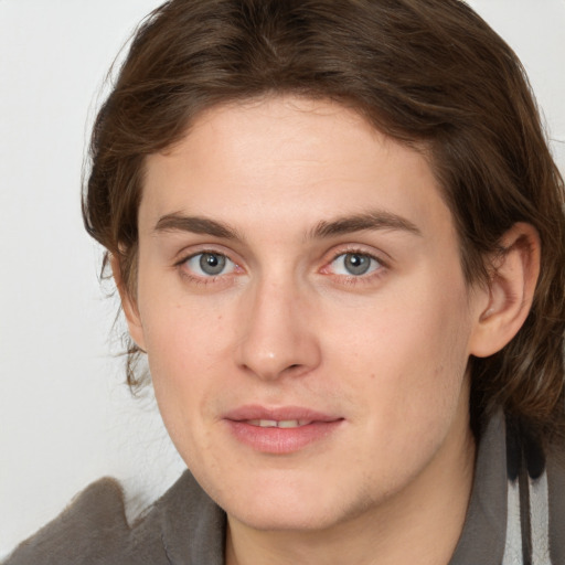 Joyful white young-adult female with medium  brown hair and grey eyes