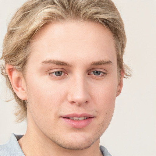 Joyful white young-adult male with short  brown hair and blue eyes