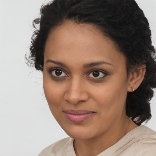 Joyful latino young-adult female with medium  brown hair and brown eyes