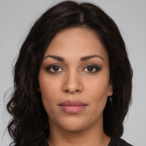 Neutral latino young-adult female with long  brown hair and brown eyes