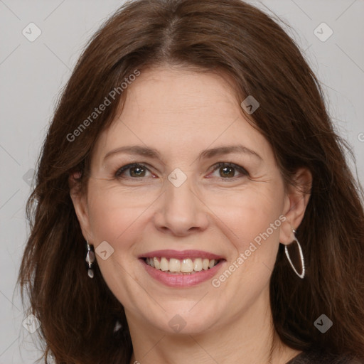 Joyful white adult female with long  brown hair and brown eyes