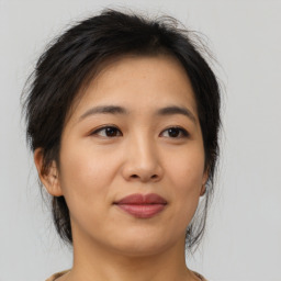 Joyful asian young-adult female with medium  brown hair and brown eyes