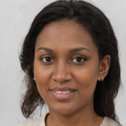 Joyful black adult female with medium  brown hair and brown eyes