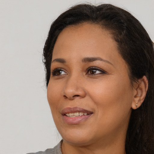 Joyful black young-adult female with medium  brown hair and brown eyes
