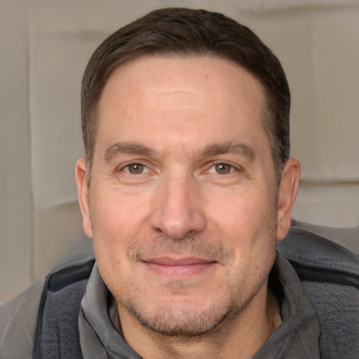 Joyful white adult male with short  brown hair and grey eyes