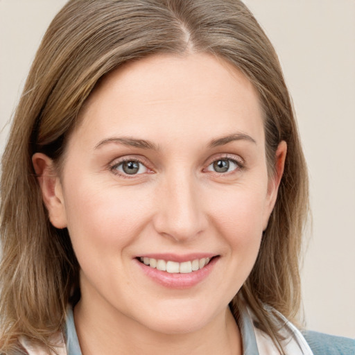 Joyful white young-adult female with medium  brown hair and blue eyes