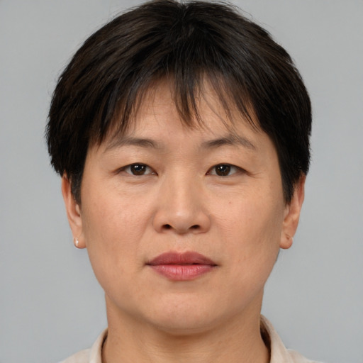 Joyful asian adult female with short  brown hair and brown eyes