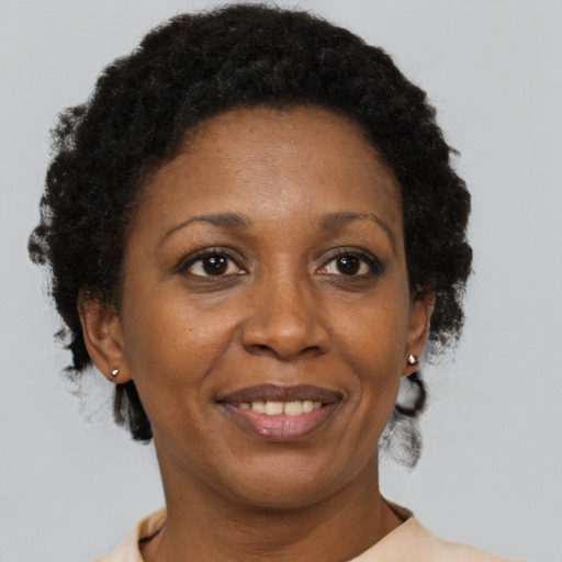 Joyful black adult female with short  brown hair and brown eyes