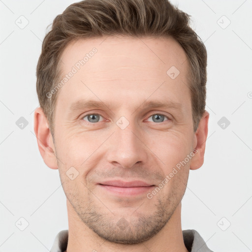 Joyful white young-adult male with short  brown hair and grey eyes