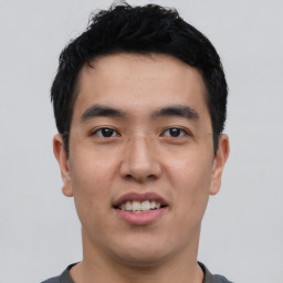 Joyful asian young-adult male with short  black hair and brown eyes