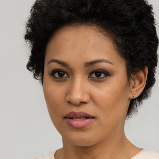 Joyful latino young-adult female with short  brown hair and brown eyes