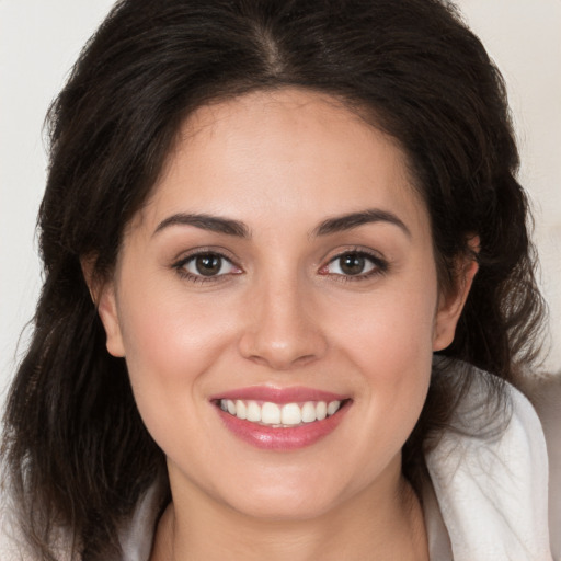 Joyful white young-adult female with medium  brown hair and brown eyes