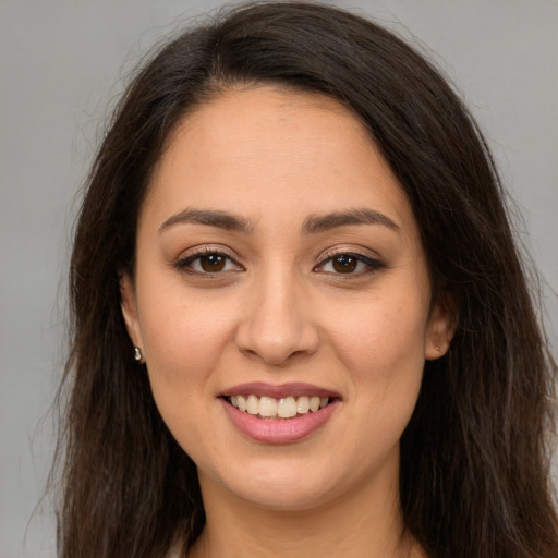Joyful white young-adult female with long  brown hair and brown eyes