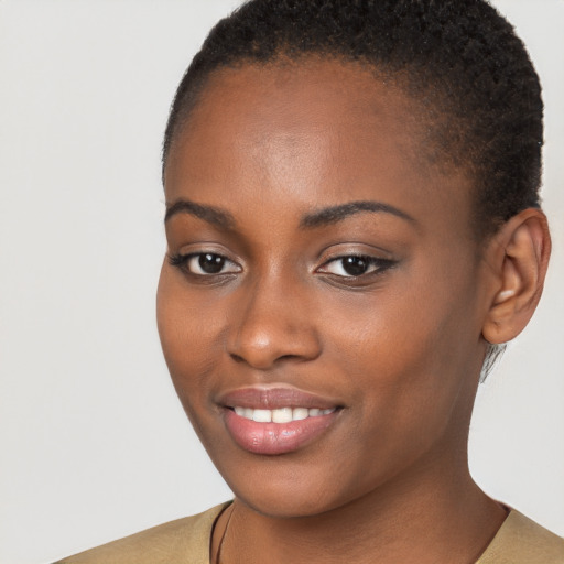 Joyful black young-adult female with short  brown hair and brown eyes