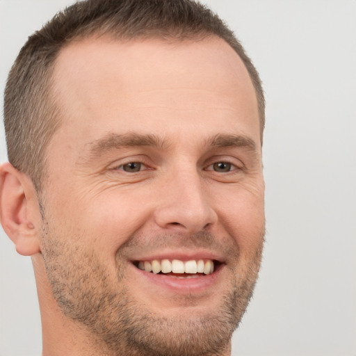 Joyful white adult male with short  brown hair and brown eyes