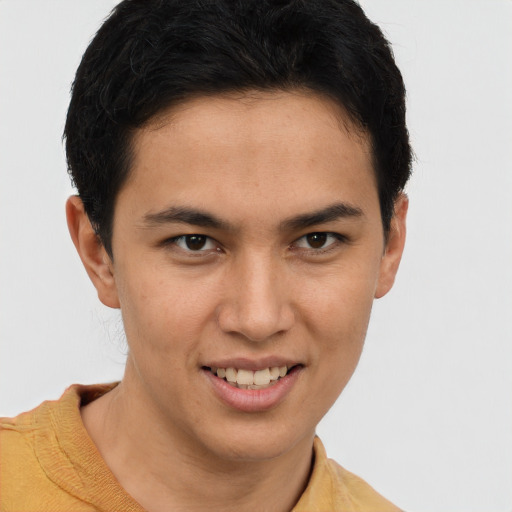 Joyful latino young-adult male with short  brown hair and brown eyes