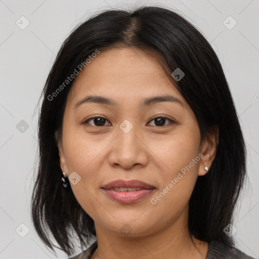 Joyful asian adult female with medium  brown hair and brown eyes