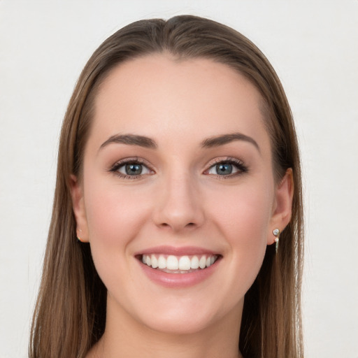 Joyful white young-adult female with long  brown hair and grey eyes