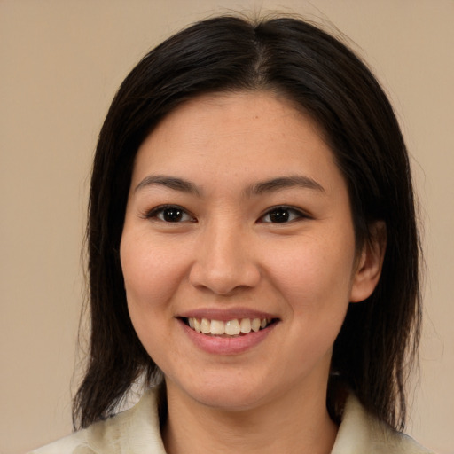 Joyful latino young-adult female with medium  brown hair and brown eyes