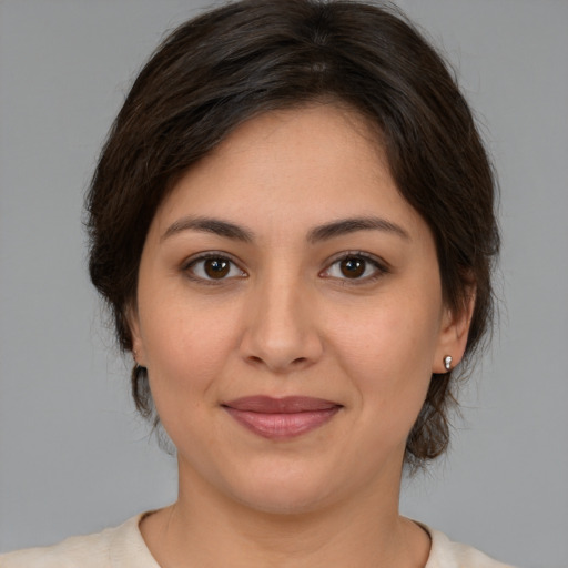 Joyful white young-adult female with medium  brown hair and brown eyes