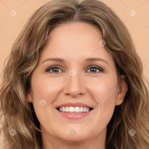 Joyful white adult female with long  brown hair and brown eyes