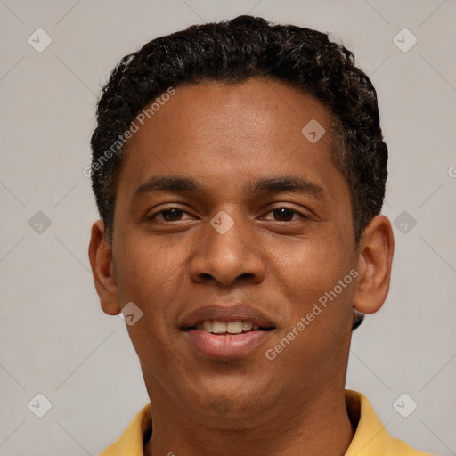 Joyful black young-adult male with short  brown hair and brown eyes