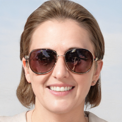 Joyful white young-adult female with medium  brown hair and blue eyes