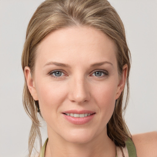 Joyful white young-adult female with medium  brown hair and blue eyes