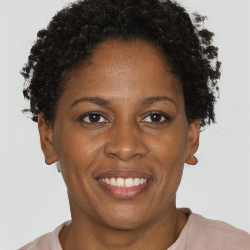 Joyful black adult female with short  brown hair and brown eyes
