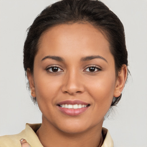 Joyful latino young-adult female with short  brown hair and brown eyes