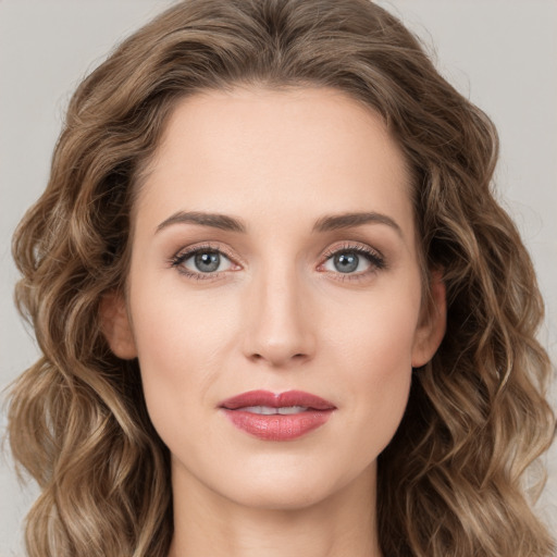 Joyful white young-adult female with long  brown hair and green eyes