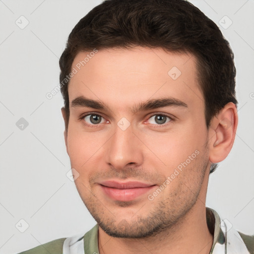 Joyful white young-adult male with short  brown hair and brown eyes