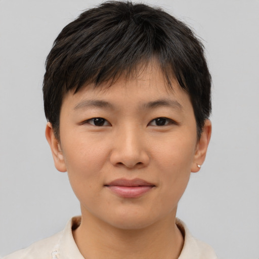 Joyful asian young-adult female with short  brown hair and brown eyes