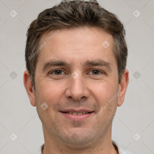 Joyful white adult male with short  brown hair and brown eyes