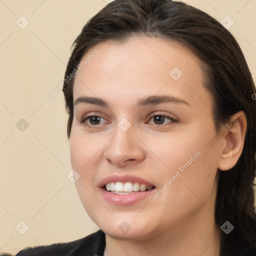 Joyful white young-adult female with long  brown hair and brown eyes