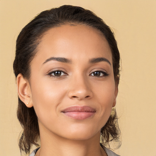 Joyful latino young-adult female with medium  brown hair and brown eyes