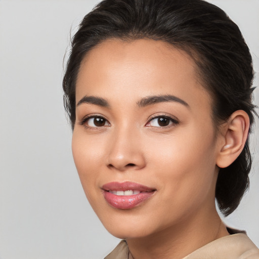 Joyful latino young-adult female with medium  brown hair and brown eyes