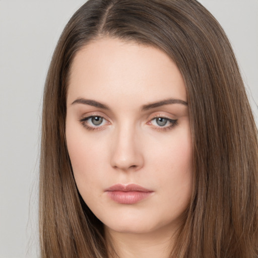 Neutral white young-adult female with long  brown hair and brown eyes