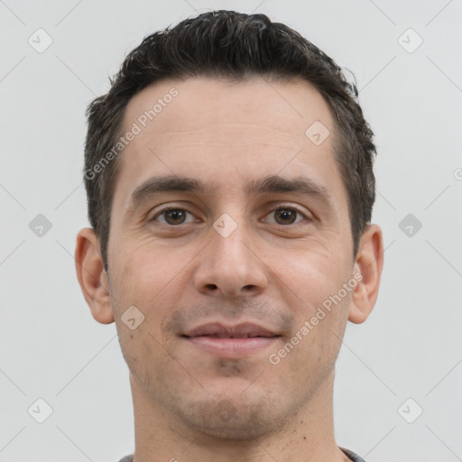 Joyful white young-adult male with short  brown hair and brown eyes