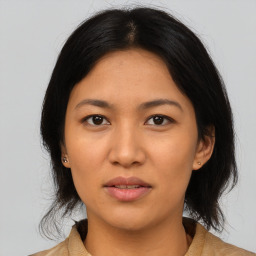 Joyful asian young-adult female with medium  black hair and brown eyes