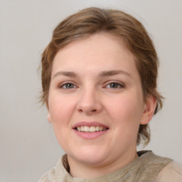 Joyful white young-adult female with medium  brown hair and grey eyes