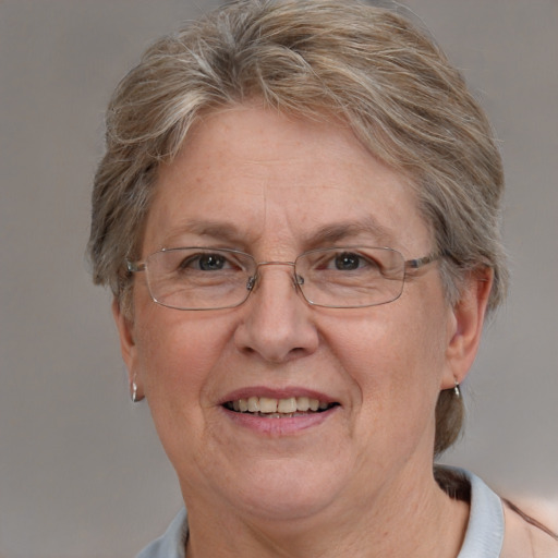 Joyful white middle-aged female with short  brown hair and blue eyes