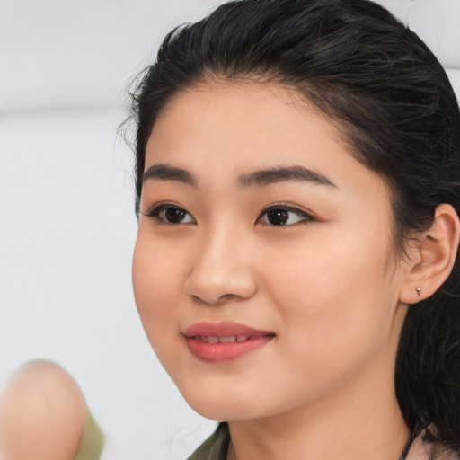 Joyful white young-adult female with medium  black hair and brown eyes