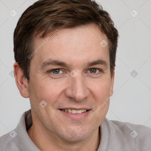 Joyful white adult male with short  brown hair and grey eyes